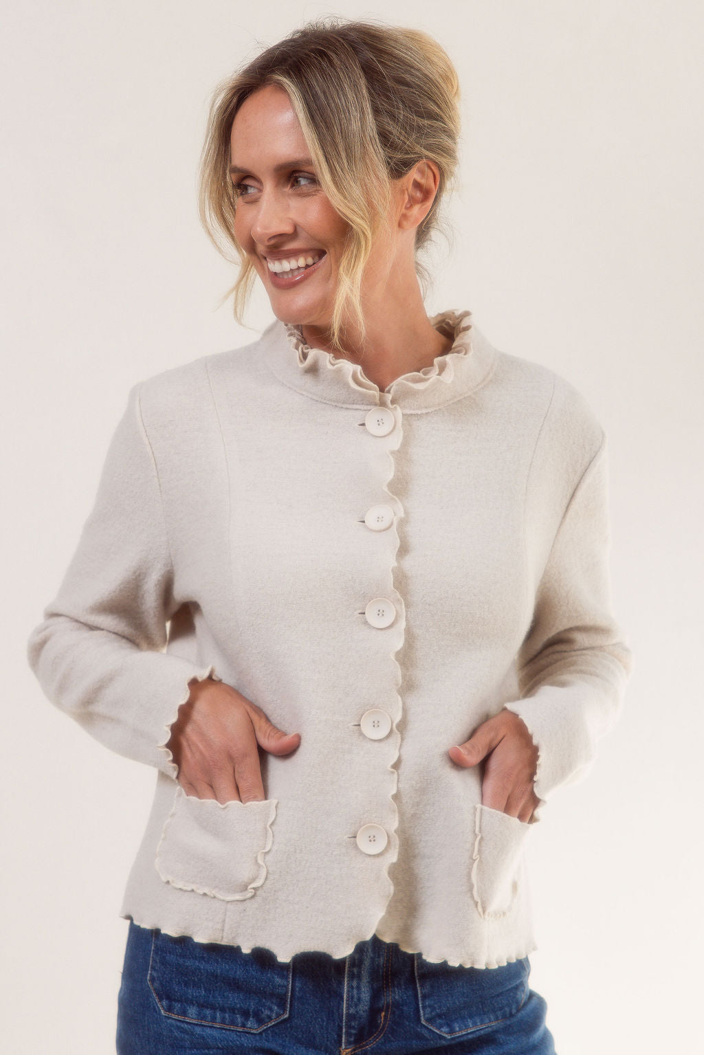 Woman wearing a See Saw cream-colored boiled wool jacket with a white background