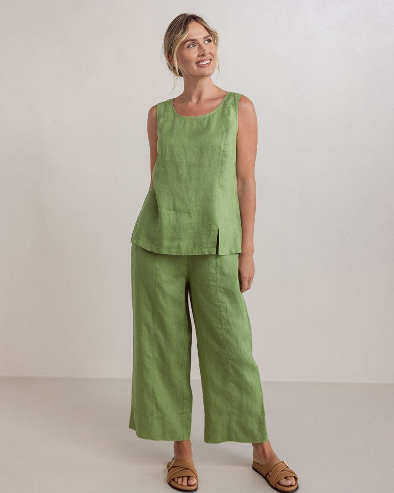 Woman wearing a pistachio linen See Saw sleeveless top and matching pants against a white background