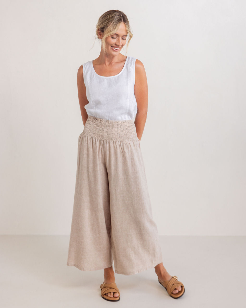 Woman wearing a white sleeveless top and beige wide-leg pants on a plain background
See Saw Linen Shell Tank Top White SS320