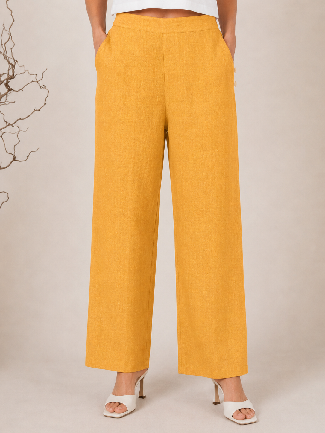 White wide-leg See Saw Palazzo linen pants shown on a model wearing white heeled sandals against a light beige background.