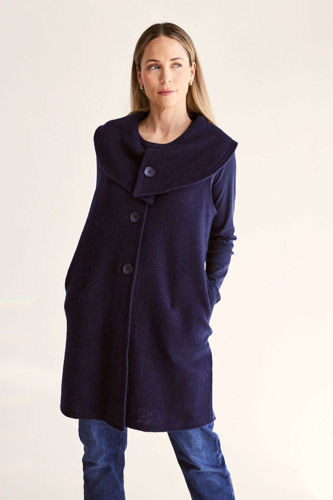 Woman wearing a navy blue See Saw Boiled Wool Vest on a white background