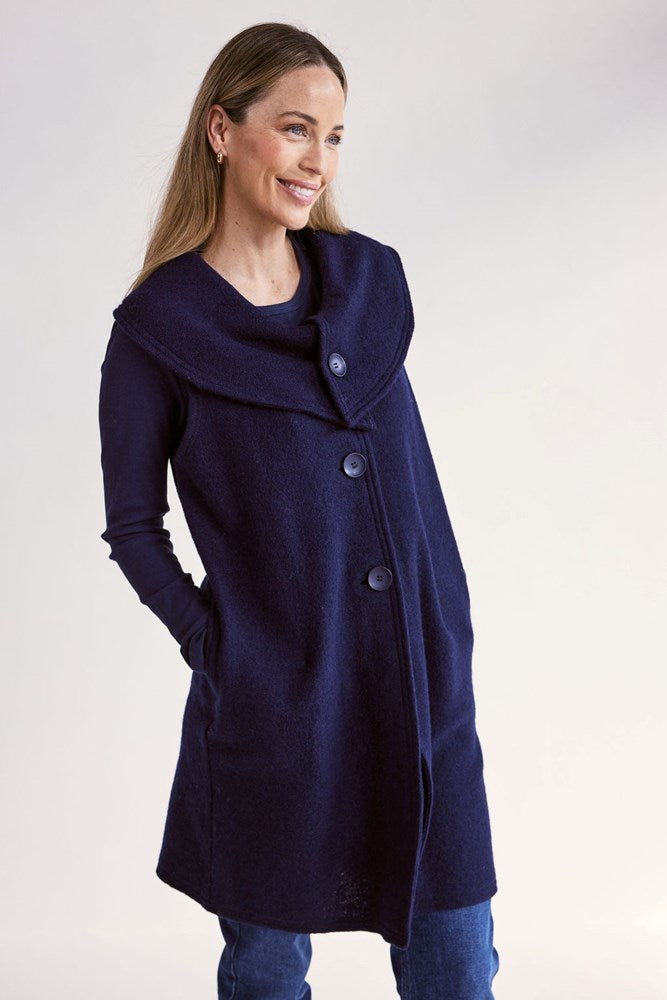 Woman wearing a navy blue See Saw Boiled Wool Vest on a white background