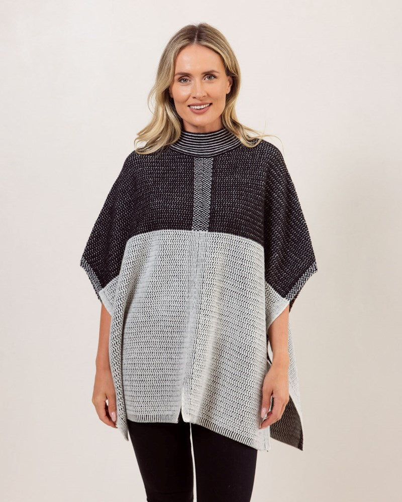 Woman wearing a black and gray See Saw Wool patterned poncho against a white background