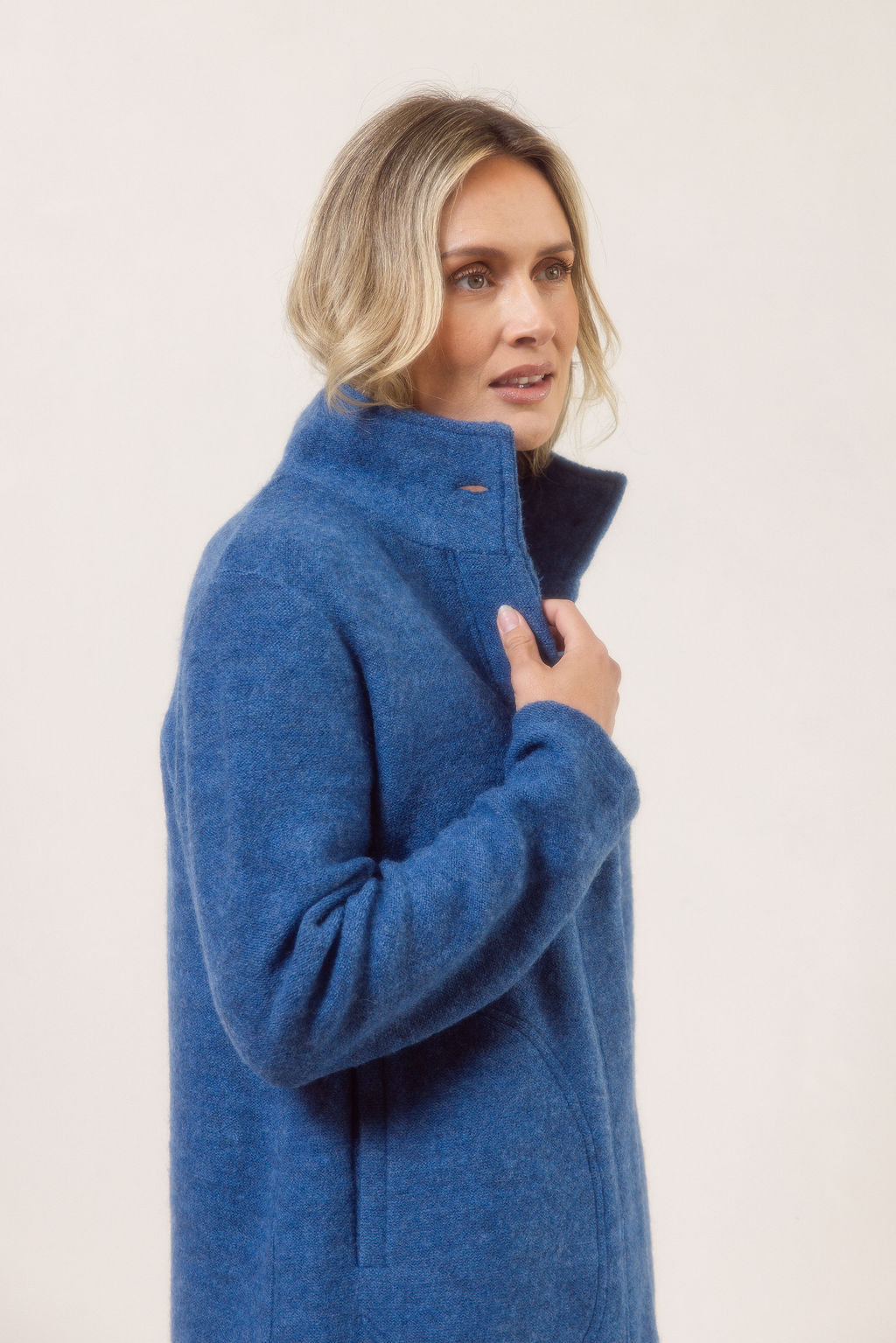 Women wearing a boiled wool funnel neck See Saw Coat against a white background