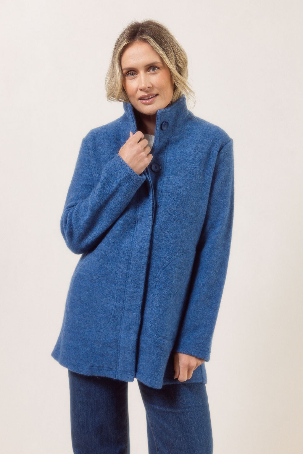 Women wearing a boiled wool funnel neck See Saw Coat against a white background