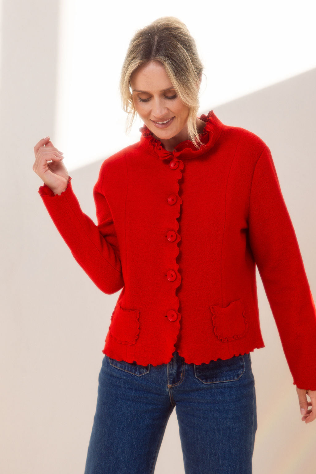 Woman wearing a See Saw red-colored boiled wool jacket with a white background