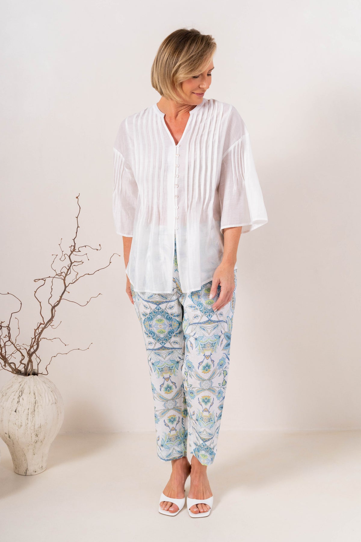 Model wearing botanica linen pants by see saw clothing. modelled against a neutral background.
