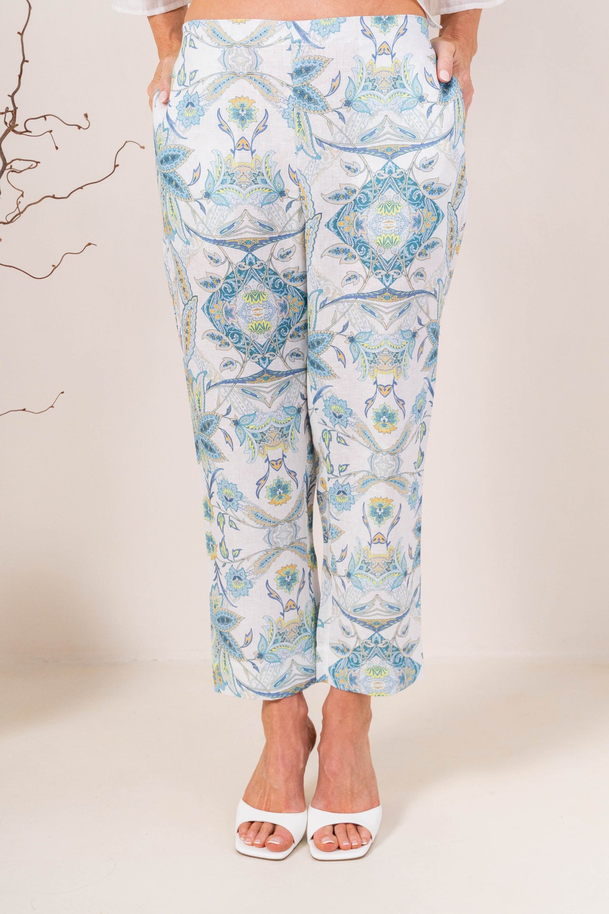 Model wearing botanica linen pants by see saw clothing. modelled against a neutral background.
