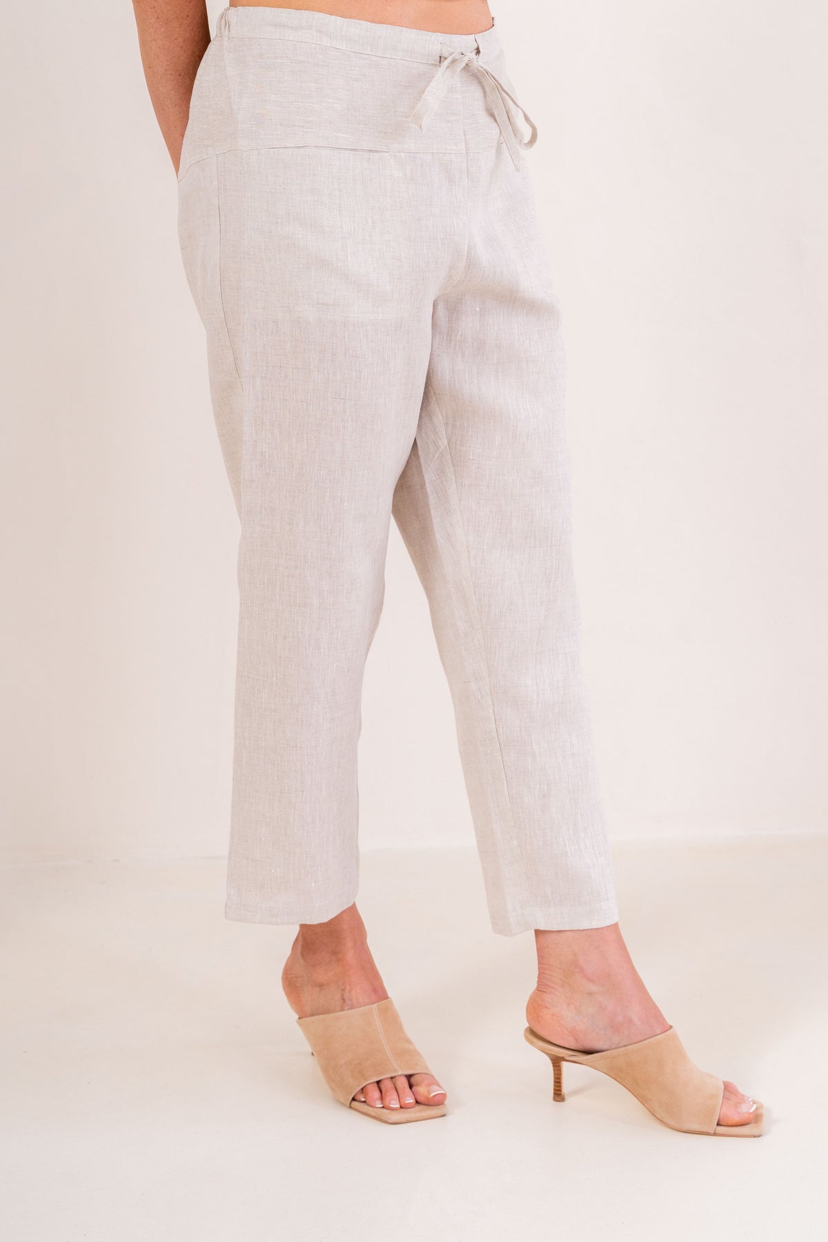 Woman wearing natural 100% linen pants by See Saw clothing.