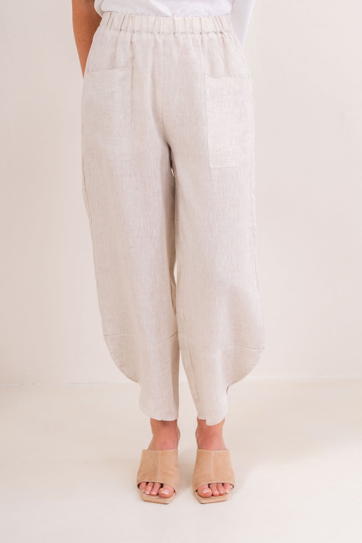 Women wearing 100% Linen See Saw 2 pocket pant against a neutral background