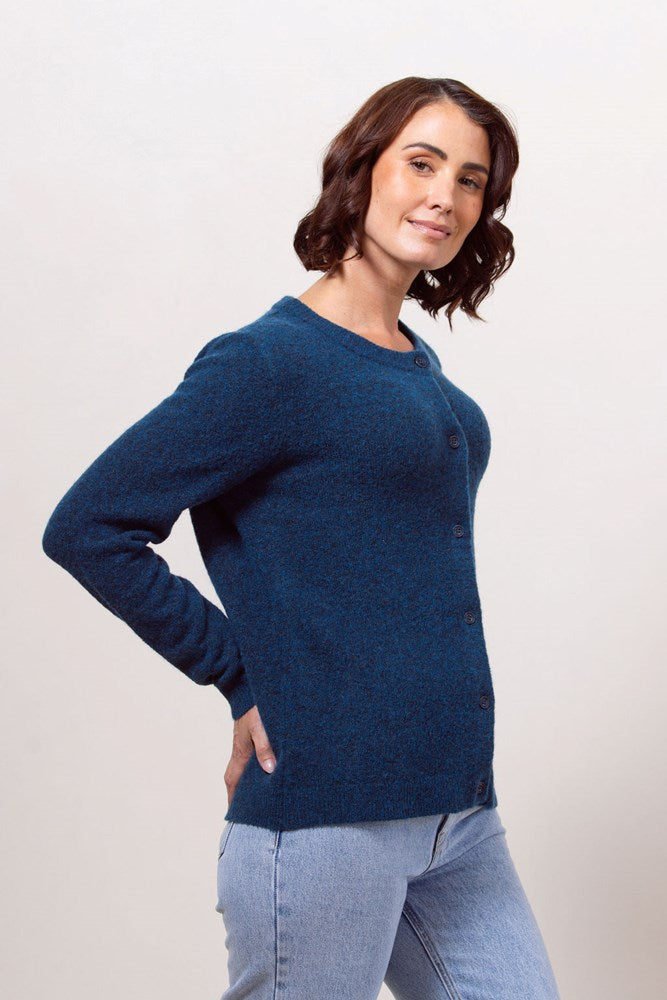 Woman wearing a blue See Saw Llama blend cardigan against a plain background