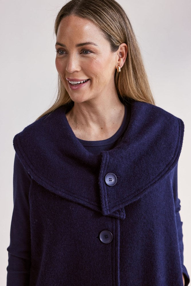 Woman wearing a navy blue See Saw Boiled Wool Vest on a white background
