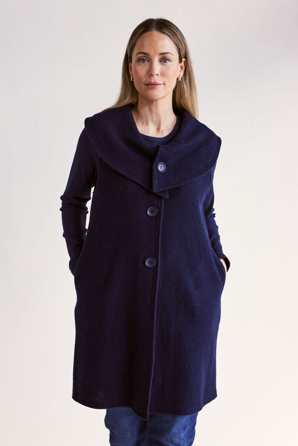 Woman wearing a navy blue See Saw Boiled Wool Vest on a white background