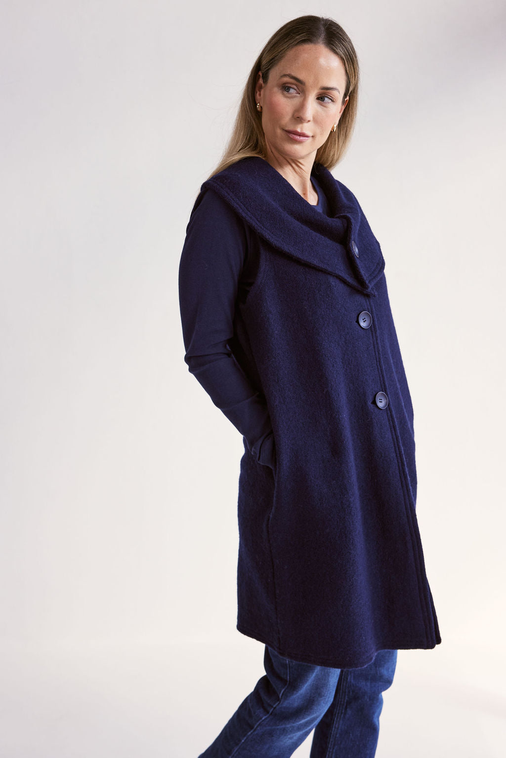 Woman wearing a navy blue See Saw Boiled Wool Vest on a white background