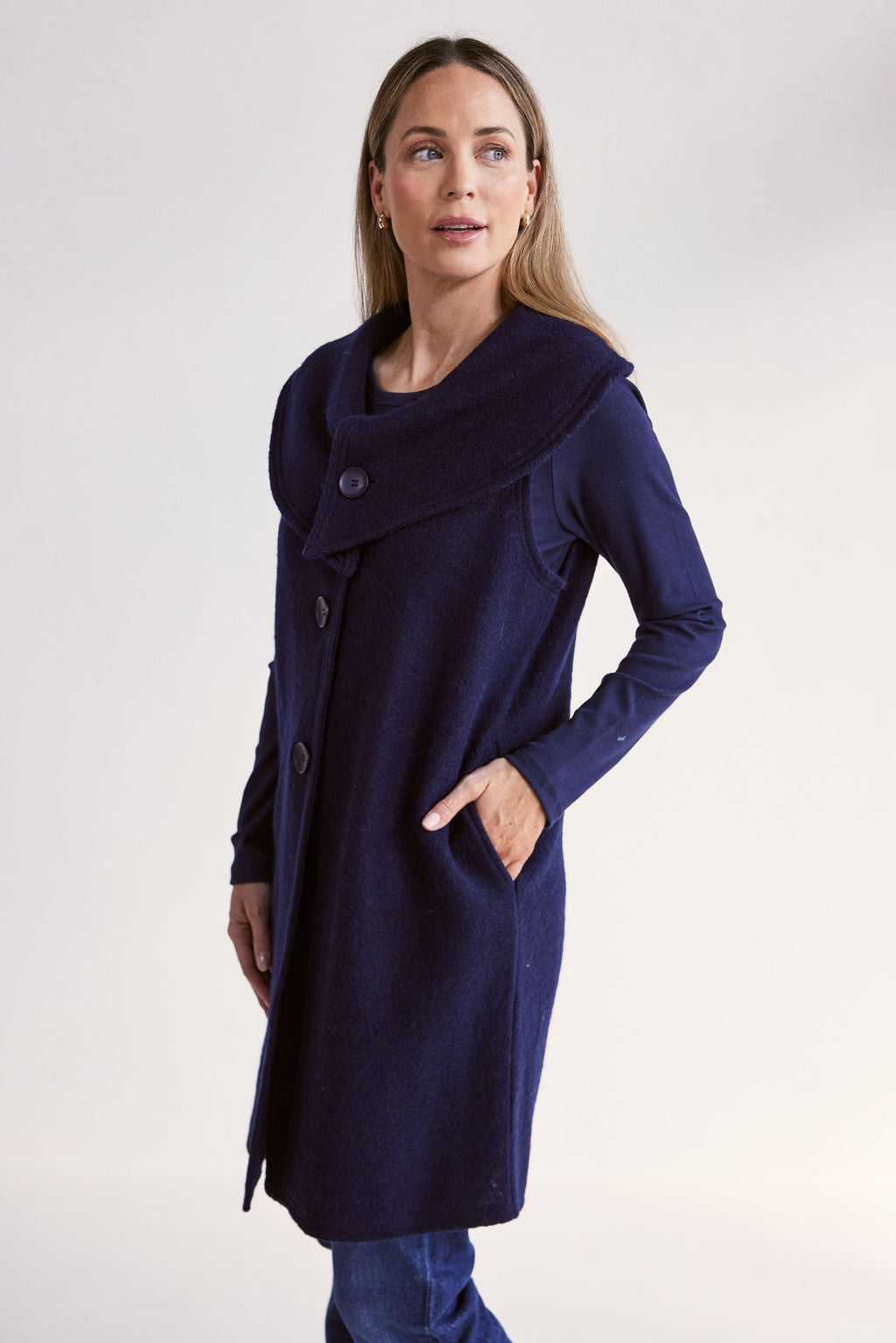 Woman wearing a navy blue See Saw Boiled Wool Vest on a white background