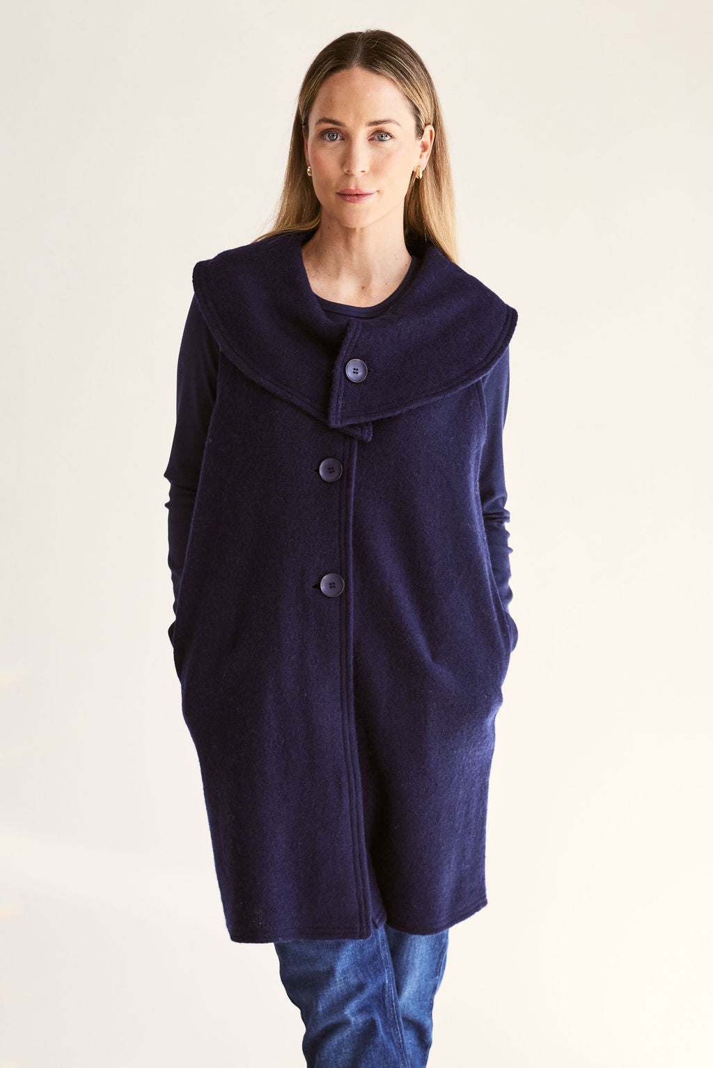 Woman wearing a navy blue See Saw Boiled Wool Vest on a white background
