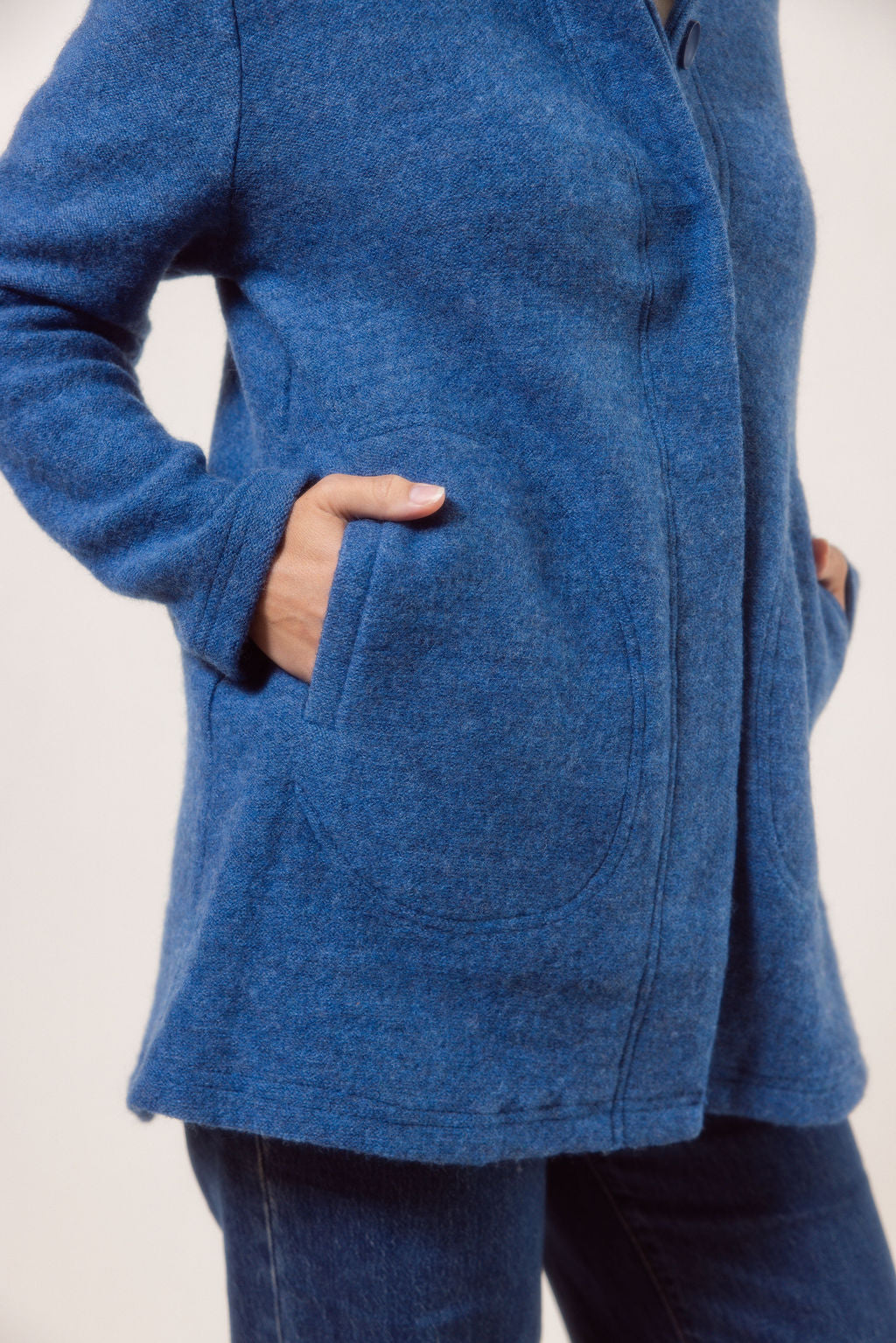 Women wearing a boiled wool funnel neck See Saw Coat against a white background