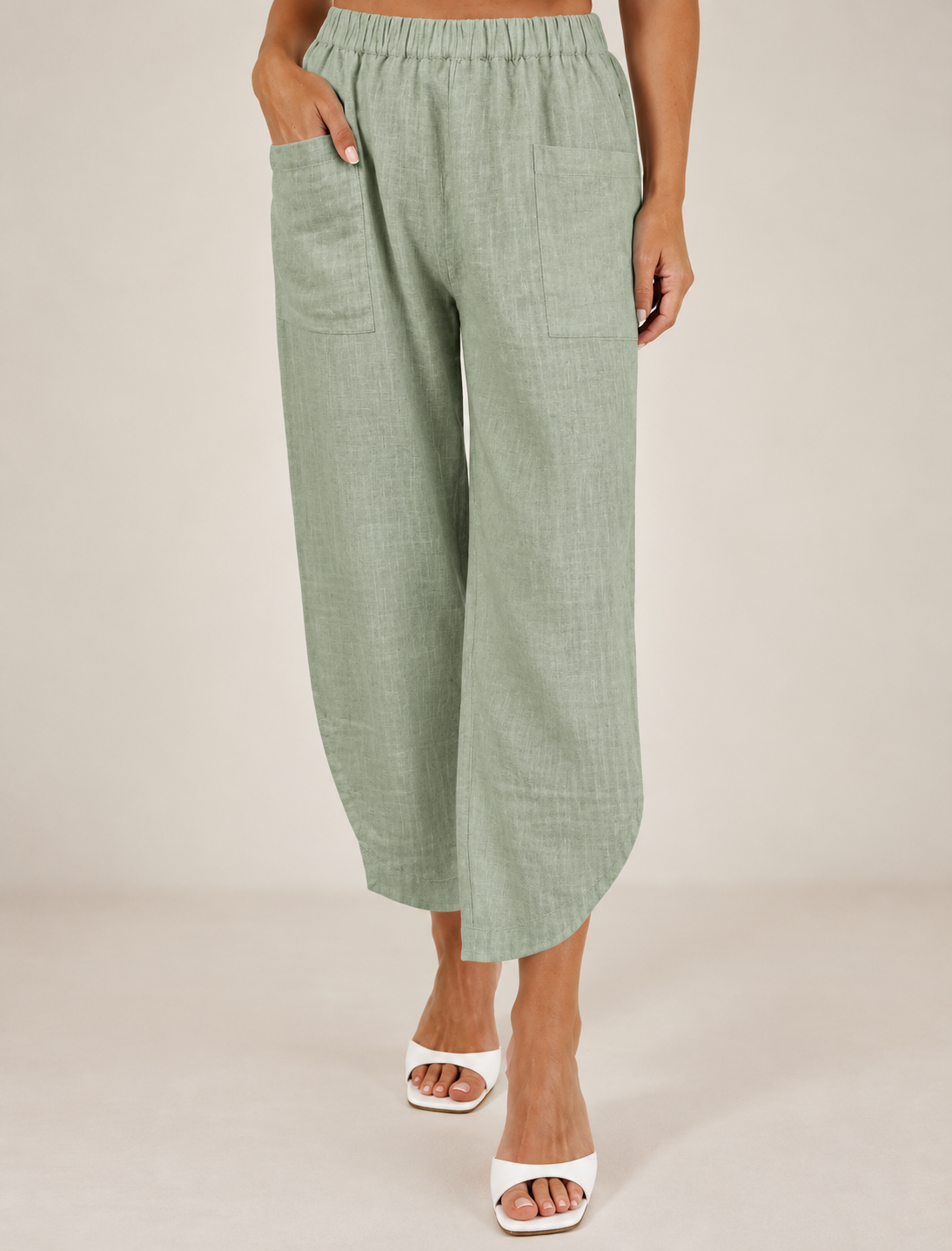 Women wearing 100% Linen See Saw  2 pocket pant in sage against a neutral background