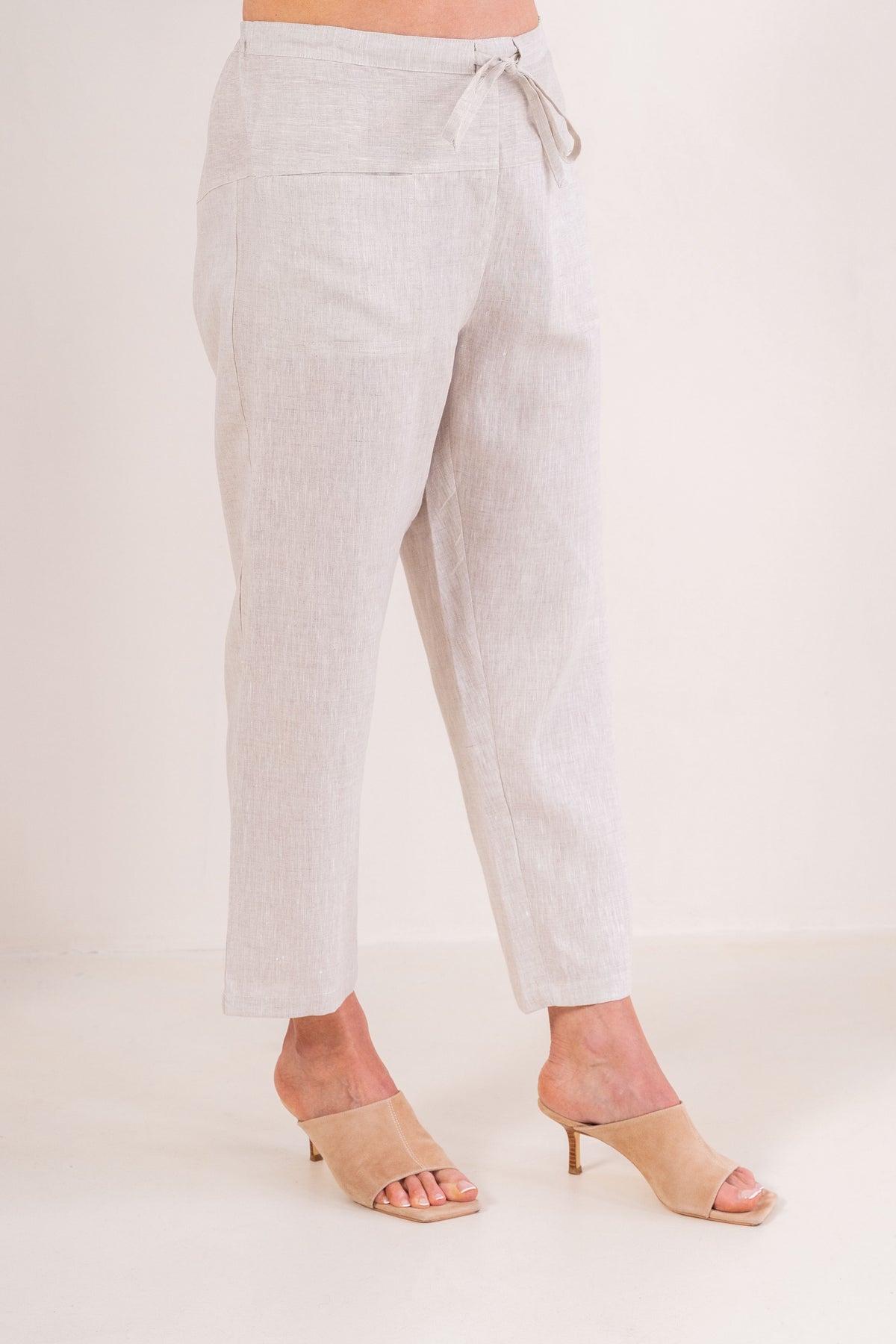 Woman wearing natural 100% linen pants by See Saw clothing.