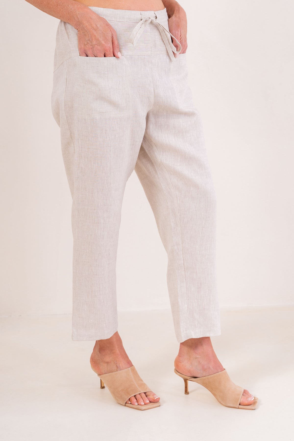 Woman wearing natural 100% linen pants by See Saw clothing.