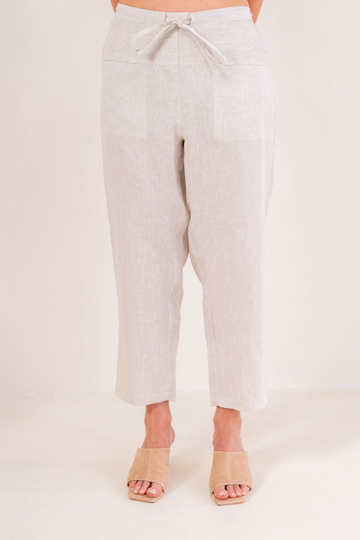 Woman wearing natural 100% linen pants by See Saw clothing.