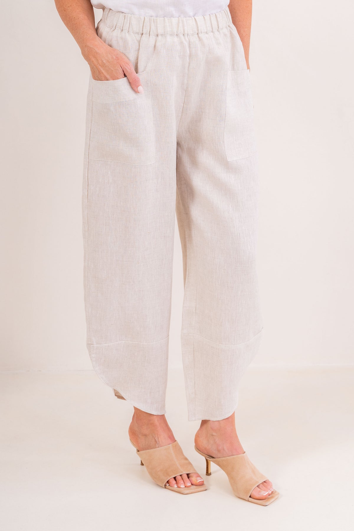 Women wearing 100% Linen See Saw 2 pocket pant against a neutral background