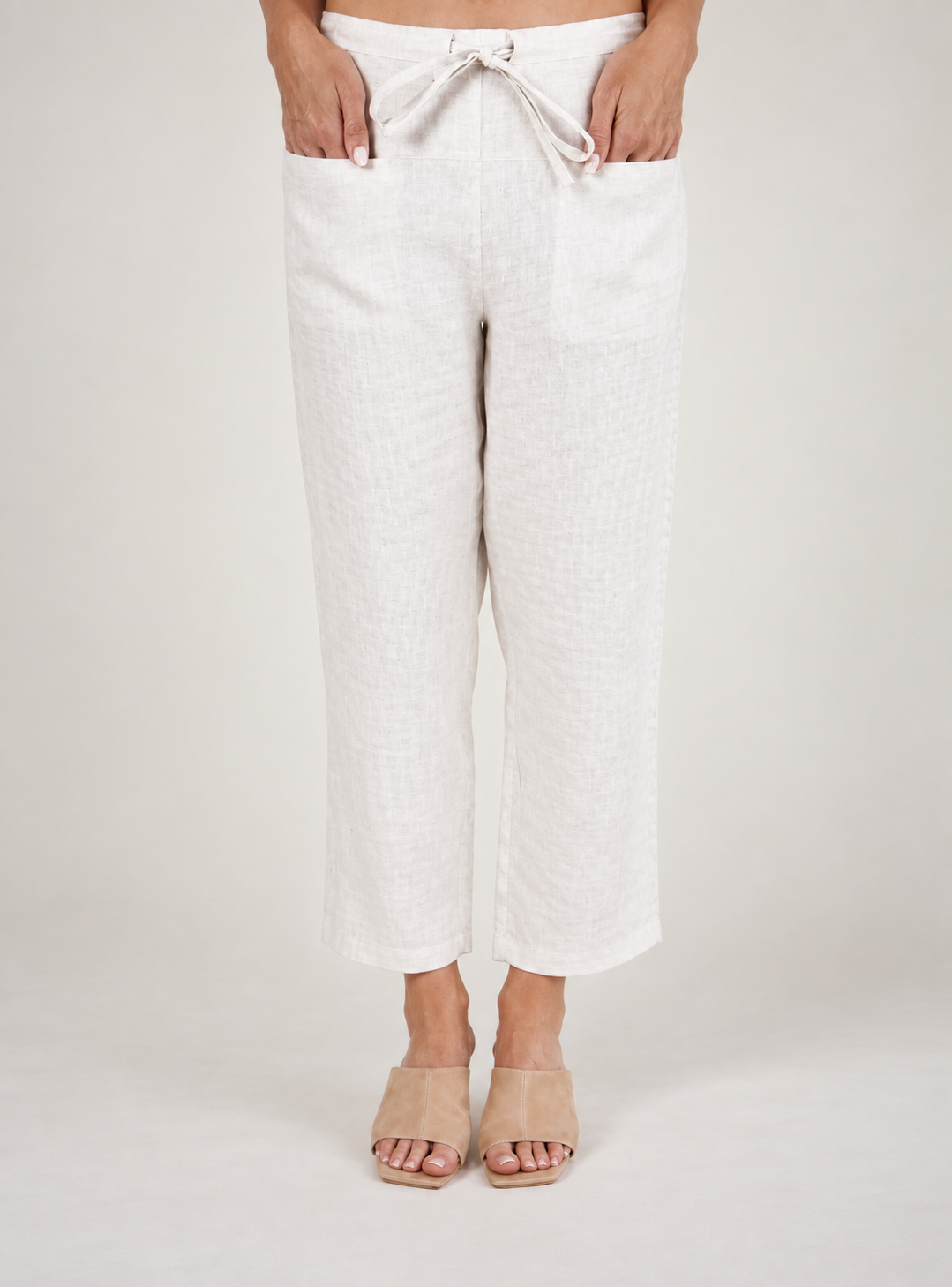 Woman wearing natural 100% linen pants by See Saw clothing.