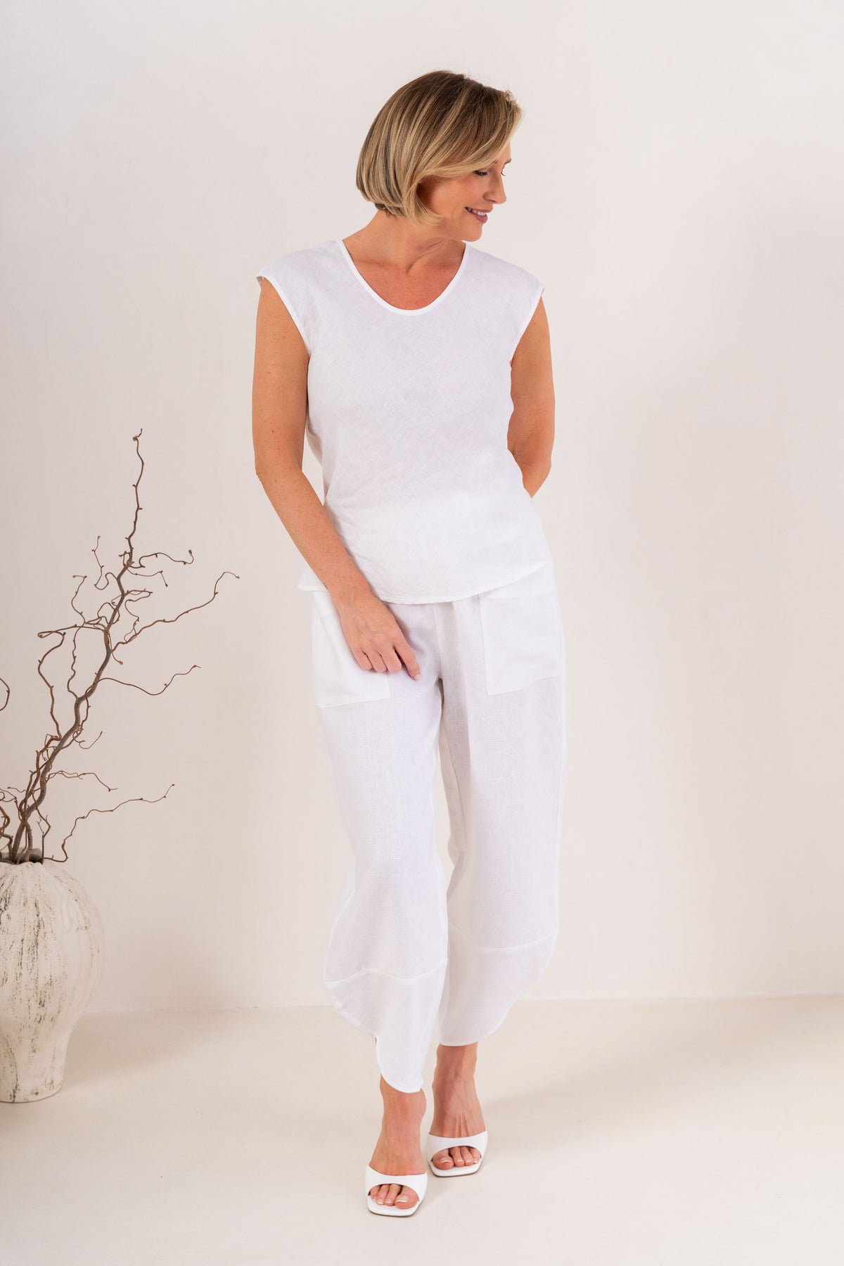 Women wearing 100% Linen See Saw 2 pocket pant against a neutral background