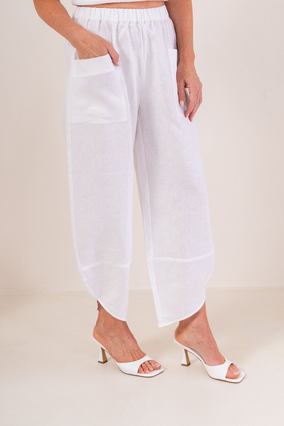 Women wearing 100% Linen See Saw 2 pocket pant against a neutral background