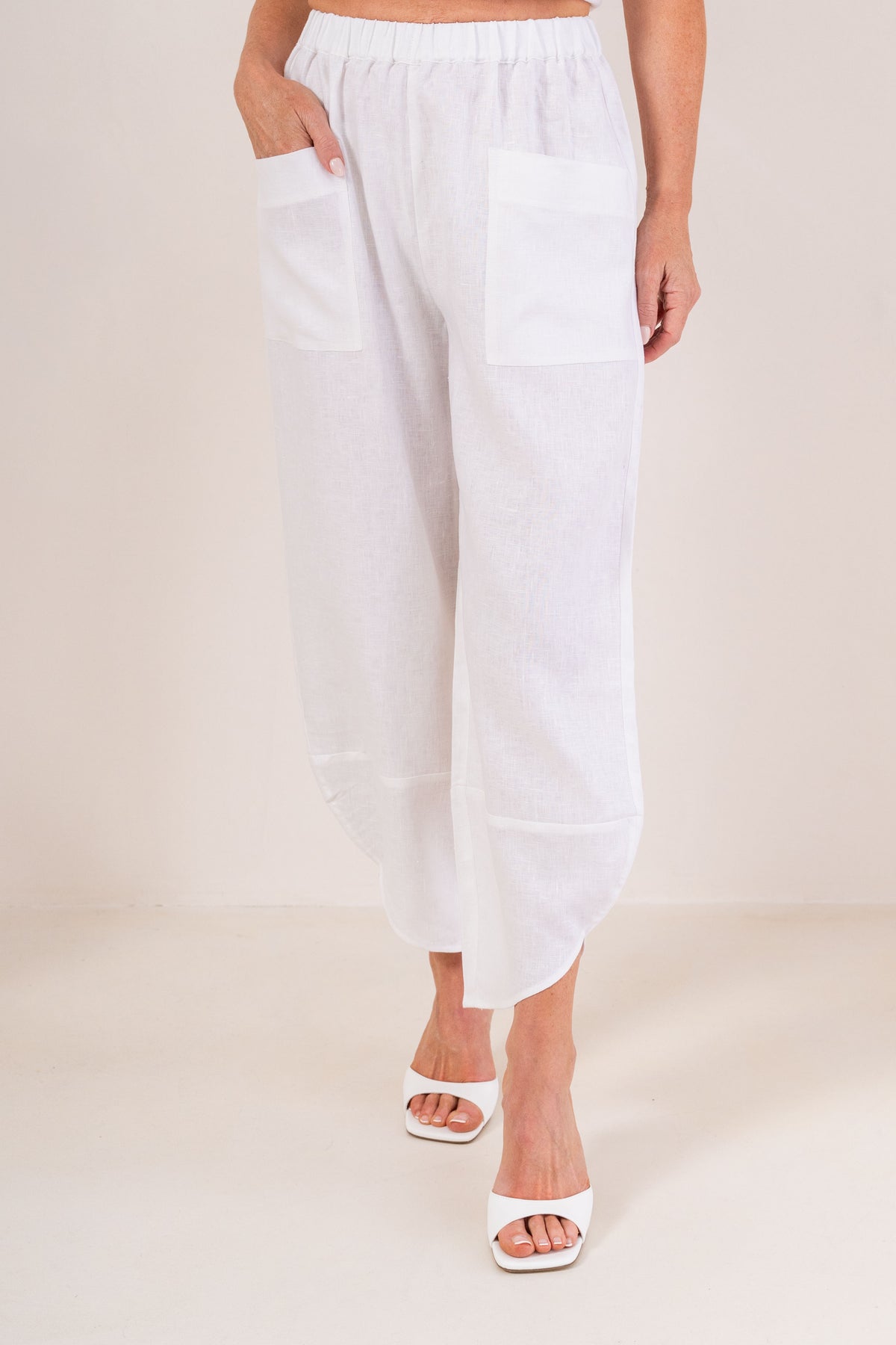 Women wearing 100% Linen See Saw 2 pocket pant against a neutral background