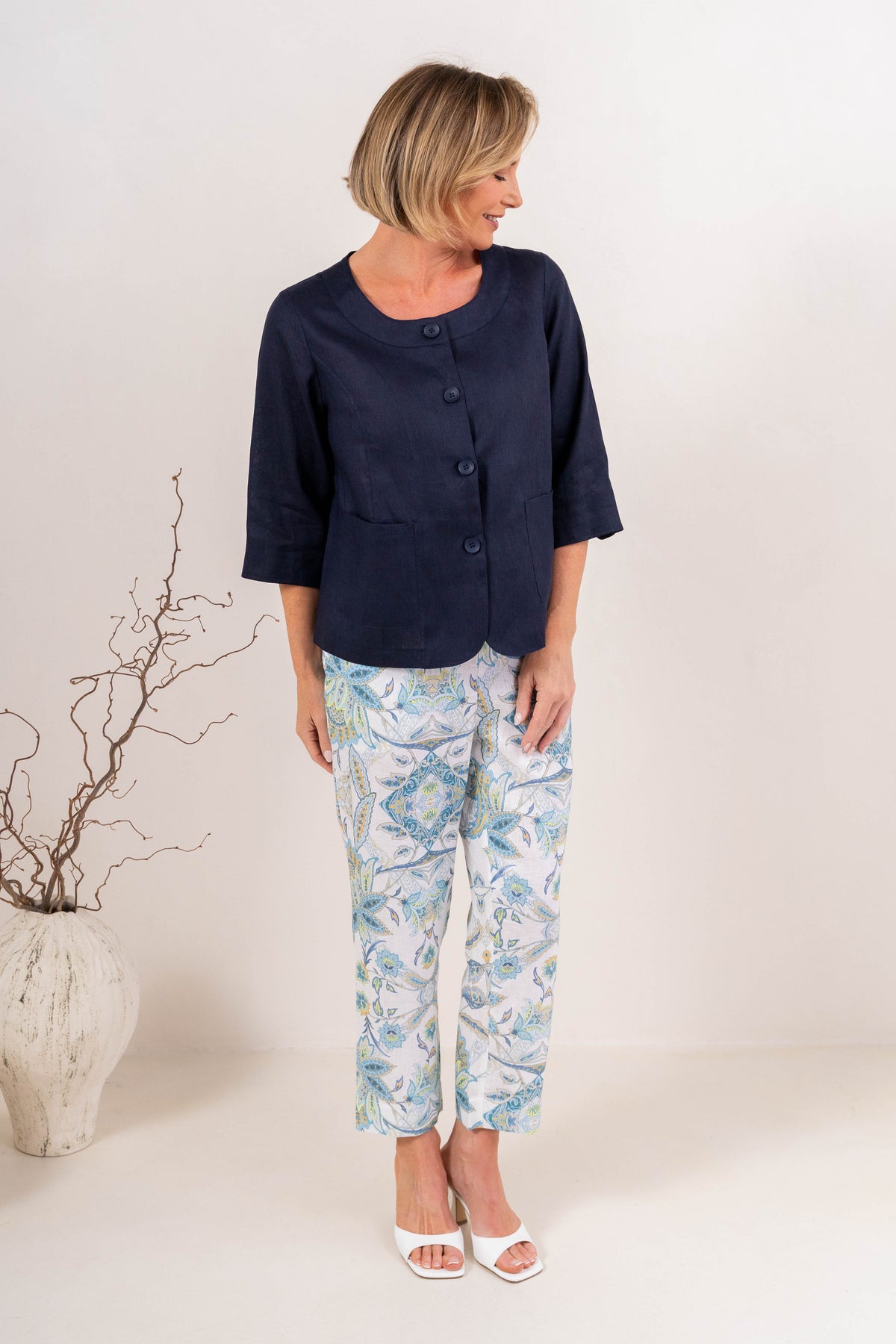 Model wearing botanica linen pants by see saw clothing. modelled against a neutral background. 